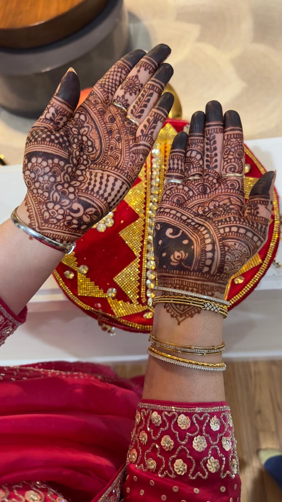 Dark henna stain color on both hands with bridal jewelry