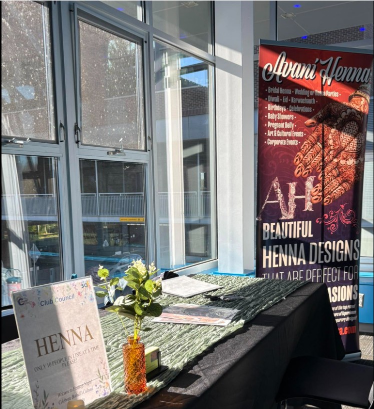 Henna artist applying mehndi at a corporate event by Avani Henna Seattle