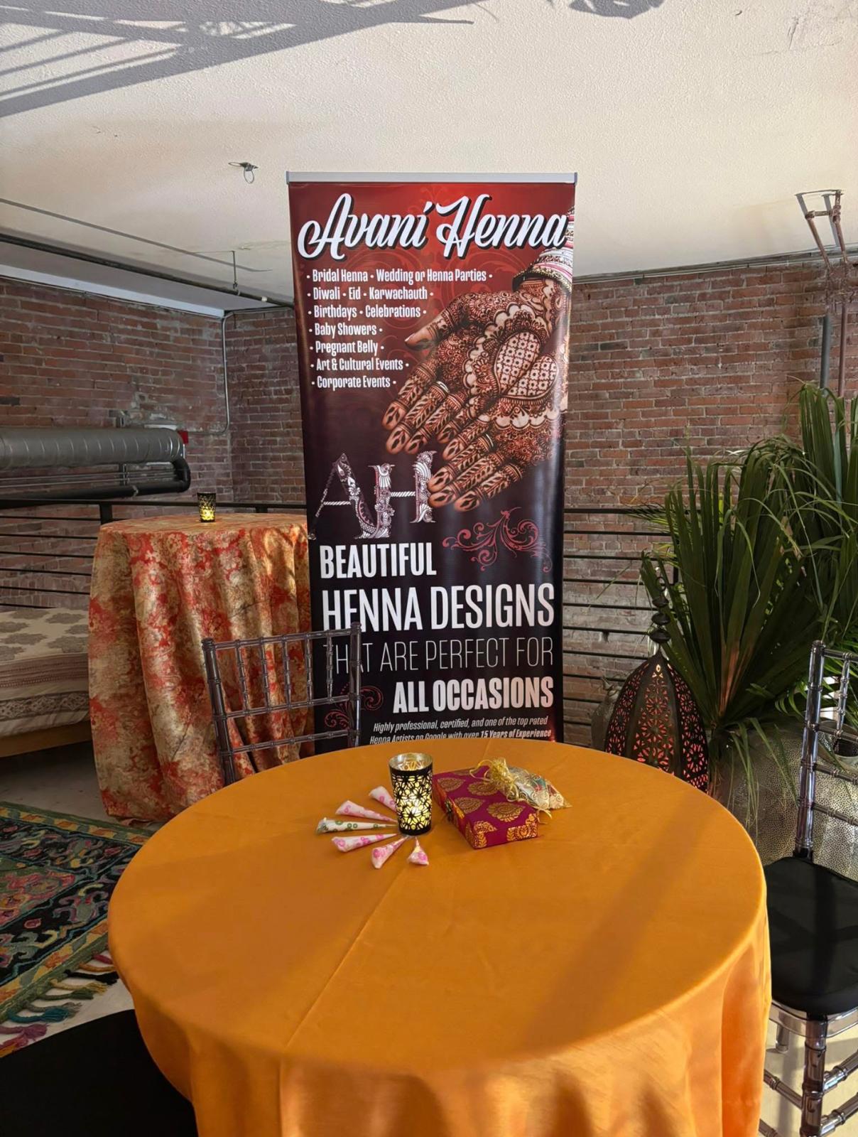 Henna artist applying design at a party in Bellevue WA by Avani Henna Seattle