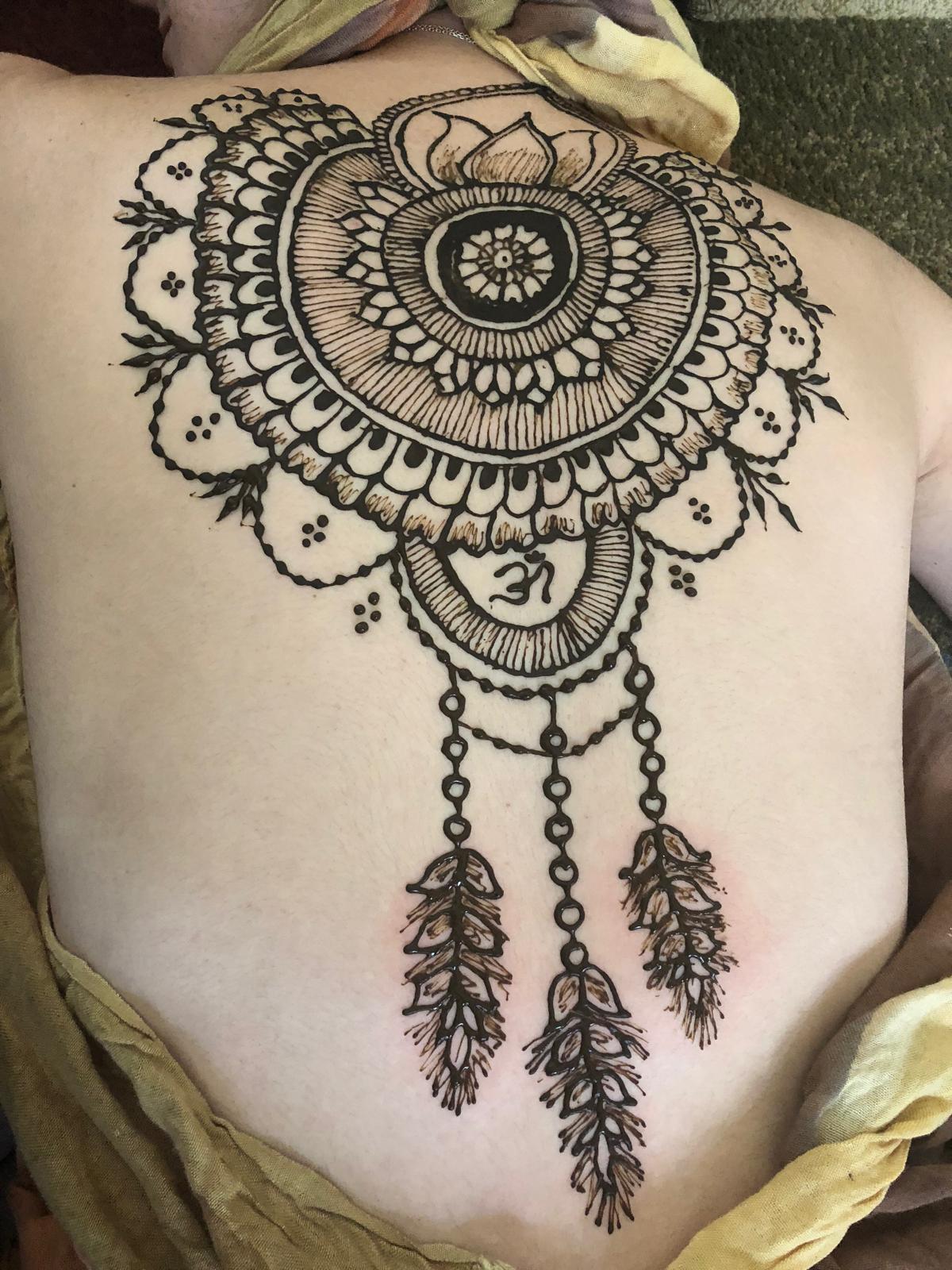 Detailed arm and hand henna applied during a private appointment